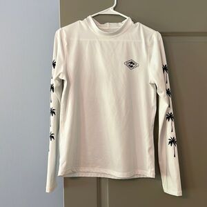 Women’s white Billabong long sleeve rash guard with palm trees UV protection